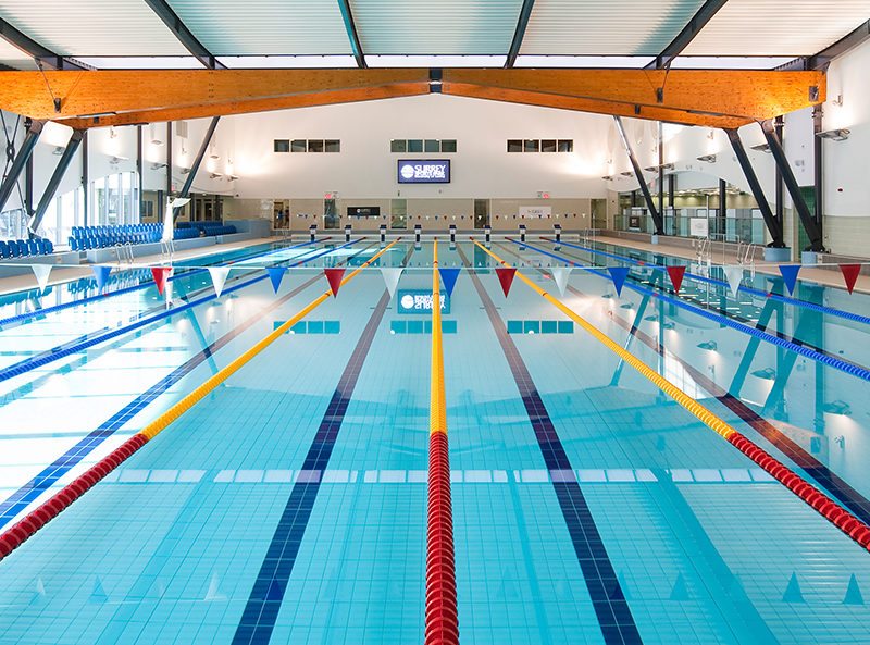 view of the Surrey Sports Park indoor olympic-sized swimming pool from the first floor walkway