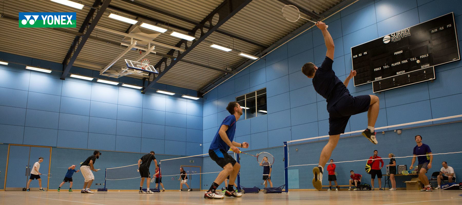 2 a side badminton players in action on the court at Surrey Sports Park