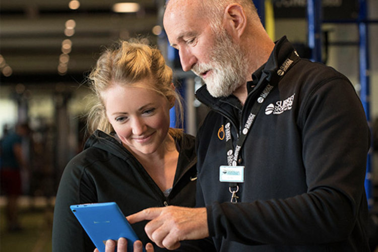 personal trainer reviewing training with a gym member at Surrey Sports Park
