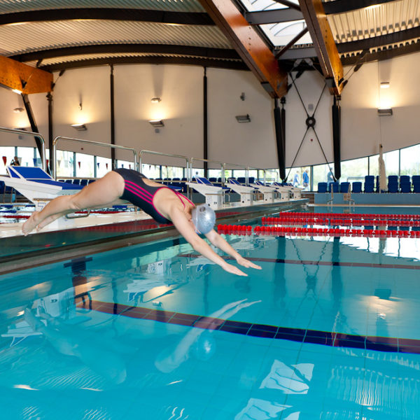 diving into the indoor swimming pool at Surrey Sports Park
